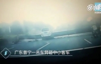 В Китае семь человек погибли при падении строительного крана на машину (видео)